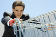 Businessman pushing grocery cart