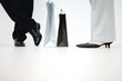 Photo: Couple standing with shopping bags between them, cropped view of feet, low angle view Couple standing with shopping bags between them, cropped view of feet, low angle view