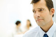 Businessman furrowing brow, looking out of frame, close-up