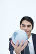 Young businessman holding globe, wearing headset