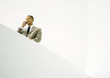Businessman using cell phone, low angle view