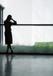 Silhouette of businesswoman using cellphone