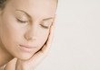 Young woman with eyes closed resting head on hand
