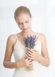 Young woman holding bouquet of lavendar