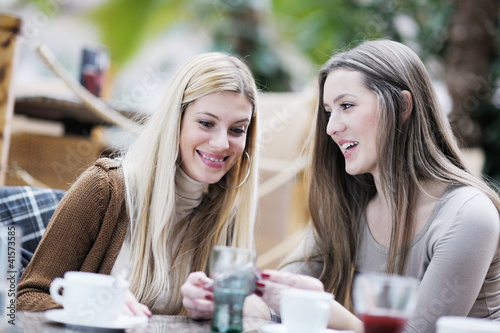 Photo: cute smiling women drinking a coffee cute smiling women drinking a coffee