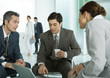 Business associates sitting in lobby having informal meeting