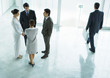 Group of business people standing in lobby, talking