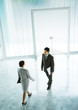 Woman walking to meet businessman in lobby