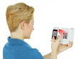 Foto: Woman scans a scancode with her white cellphone Woman scans a scancode with her white cellphone