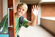 cute high school boy waving good bye