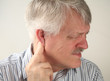 senior man suffers from pressure behind his ear