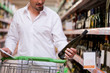 Male Shopper Looking at Liquor Bottle