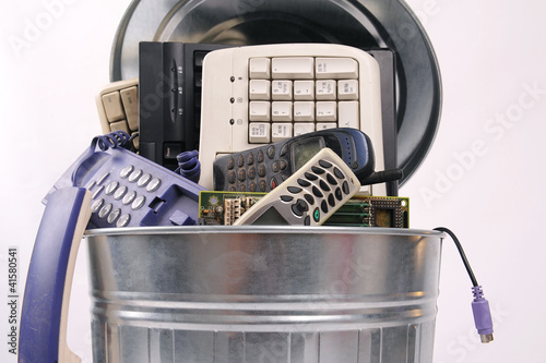 Photo: different computer parts and phone in trash can different computer parts and phone in trash can