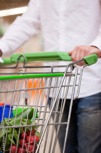 Photo: Male Shopper with Trolley at Supermarket Male Shopper with Trolley at Supermarket