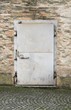 weathered security door on brick wall