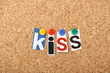 KISS in cut out letters pinned to a cork board KISS in cut out letters pinned to a cork board