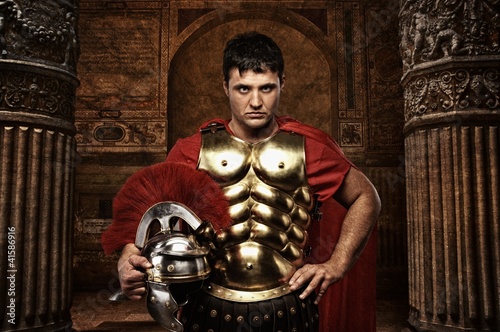 Photo: Roman soldier against antique building. Roman soldier against antique building.