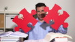 Student holding jigsaw puzzle pieces