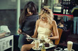 Two women reading a newspaper