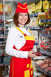 Photo: the woman seller in food supermarket the woman seller in food supermarket