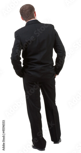 Photo: back view of Business man looks ahead. Young guy in black suit back view of Business man looks ahead. Young guy in black suit