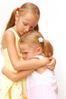 two sad sisters hugging each other