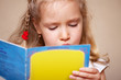 Little girl reading book