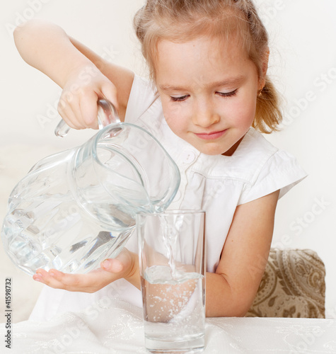 Photo: Child with glass pitcher water Child with glass pitcher water