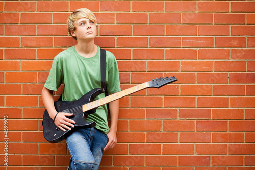 Photo: teen boy with guitar daydreaming teen boy with guitar daydreaming