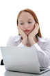 Young business woman using a laptop computer on the table isolat