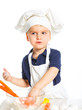 Beautiful caucasian boy making a cake