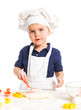 Beautiful caucasian boy making a cake