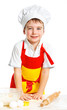 Beautiful caucasian boy making a cake
