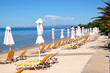 Sunbeds on a beach and turquoise water at the modern luxury hote