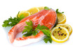 Red fish with lemon, parsley and pepper isolated on white.