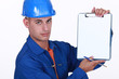 Tradesman holding up a blank clipboard