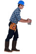 Builder carrying brick