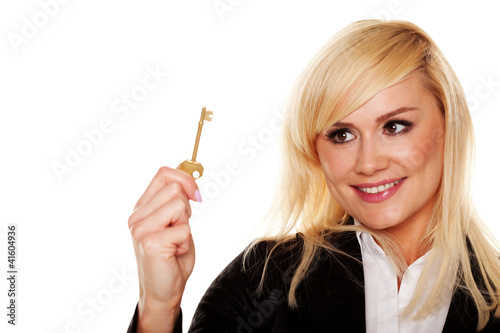 Foto: Successful woman holding brass key Successful woman holding brass key