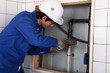 Plumber screwing pipe