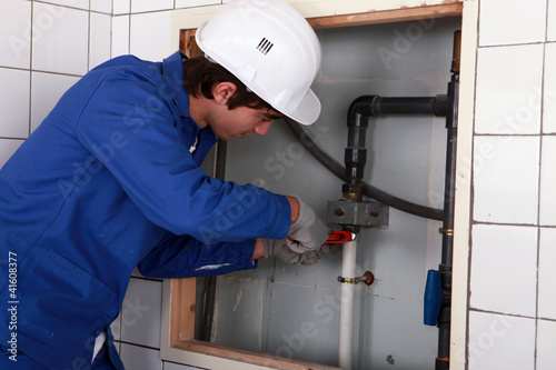 Photo: Plumber screwing pipe Plumber screwing pipe