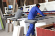 Two men using factory equipment