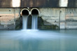 Dirty drain polluting a river