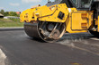 Roadwork road roller at hot asphalt