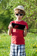 Foto: The fair-haired boy in a hat with a computer The fair-haired boy in a hat with a computer