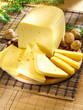 Ararangement with cheese on the kitchen cutting board.
