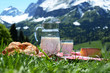 Milk, cheese and bread against Alpine scenery