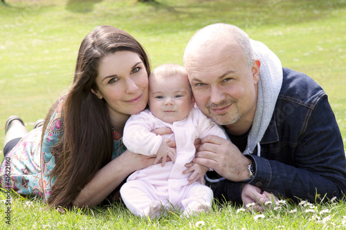Photo: happy family together on grass happy family together on grass