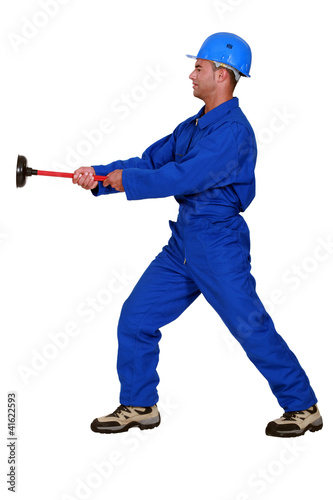 Photo: Worker with a plunger Worker with a plunger