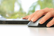 Hands Working on Laptop Computer and Mouse