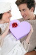 Couple holding heart-shaped box